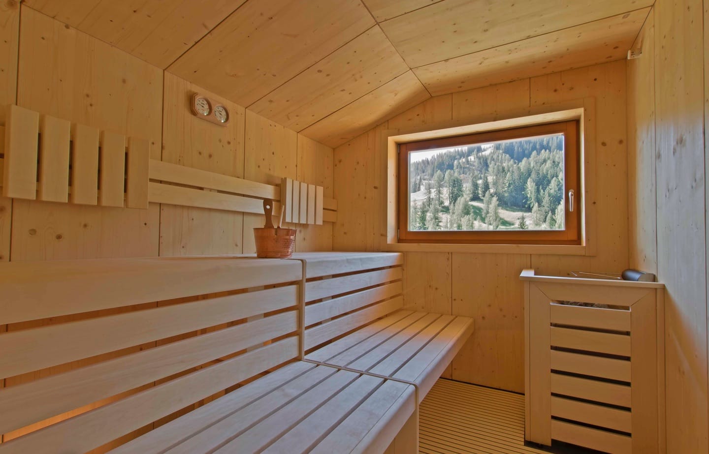The relaxation area in the wellness space overlooks the magnificent woods of San Cassiano.